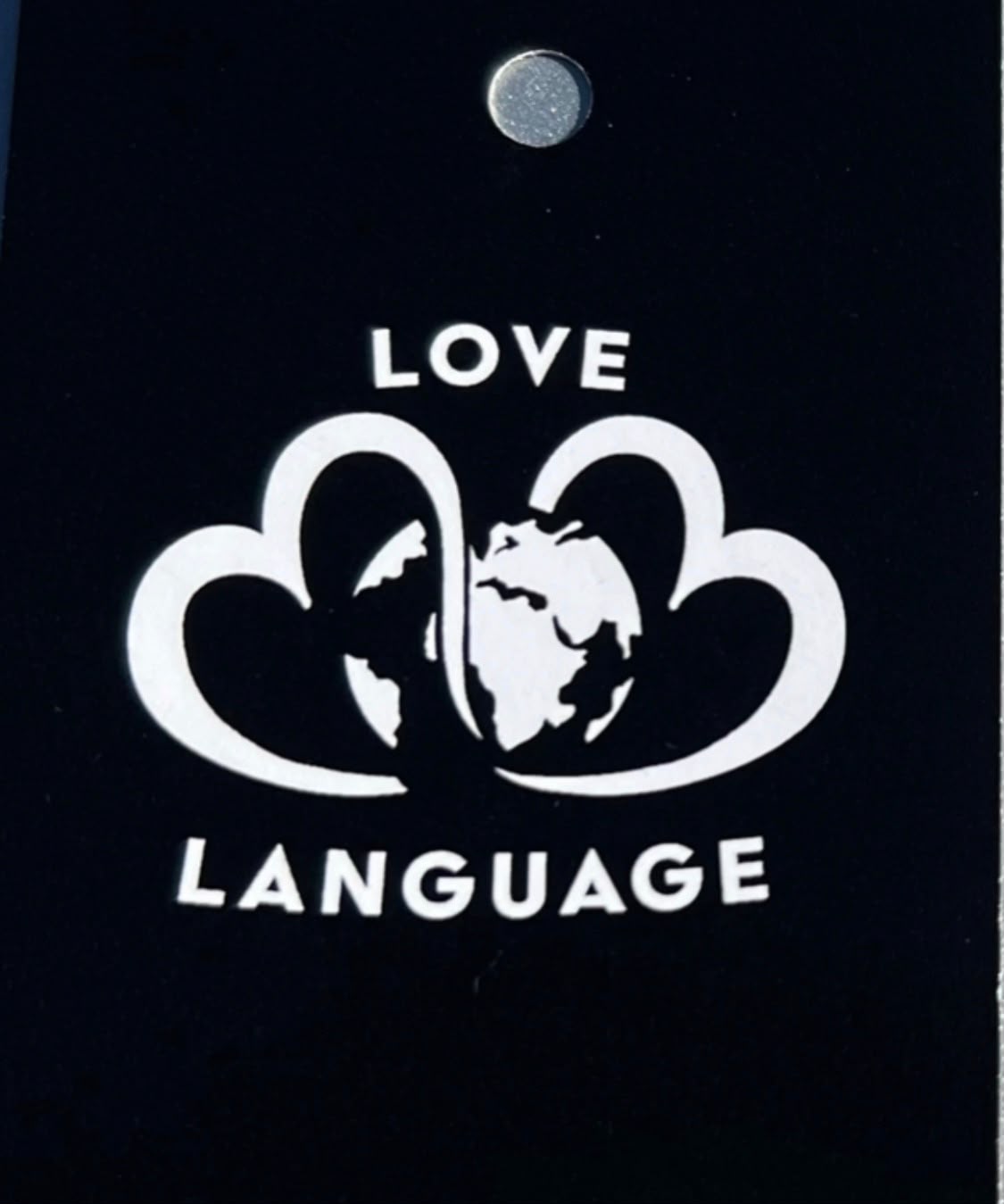 Love Language black hang tag with white twin-heart globe logo